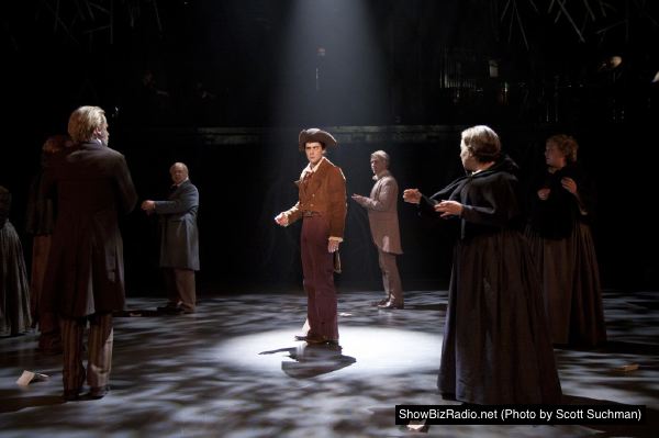 Sam Ludwig (center, as Ichabod Crane) finds himself surrounded by the frightened residents of Tarrytown