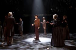 Sam Ludwig (center, as Ichabod Crane) finds himself surrounded by the frightened residents of Tarrytown