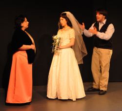 Benjamin Braddock (Zachary Hamilton) attempts to kidnap Elaine (Heather Martin) from her wedding, while Mrs Robinson (Rachel Duda) intervenes.