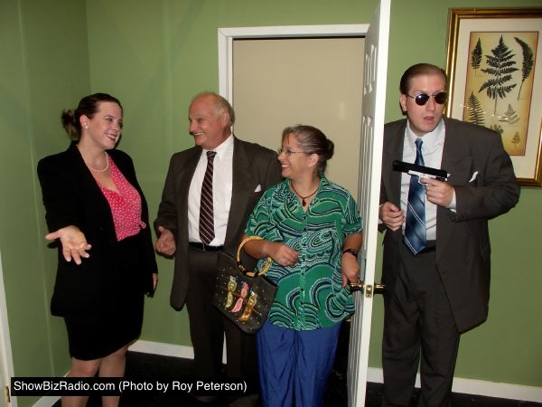 Accountant Karen Brown (Shirley Panek) welcomes Mayor Meekly and his wife Mary (Ken Kienas and Rachel Duda) to her<br>motel room while the Mayor's security guard Agent Frank (Eric Small) prepares to protect the two of them.<br>