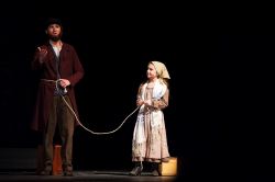 Tateh (Landon Fleischman) ties his Little Girl (Alyssa Herman) to him on a rope when they set out of New York City looking for work outside the tenements
